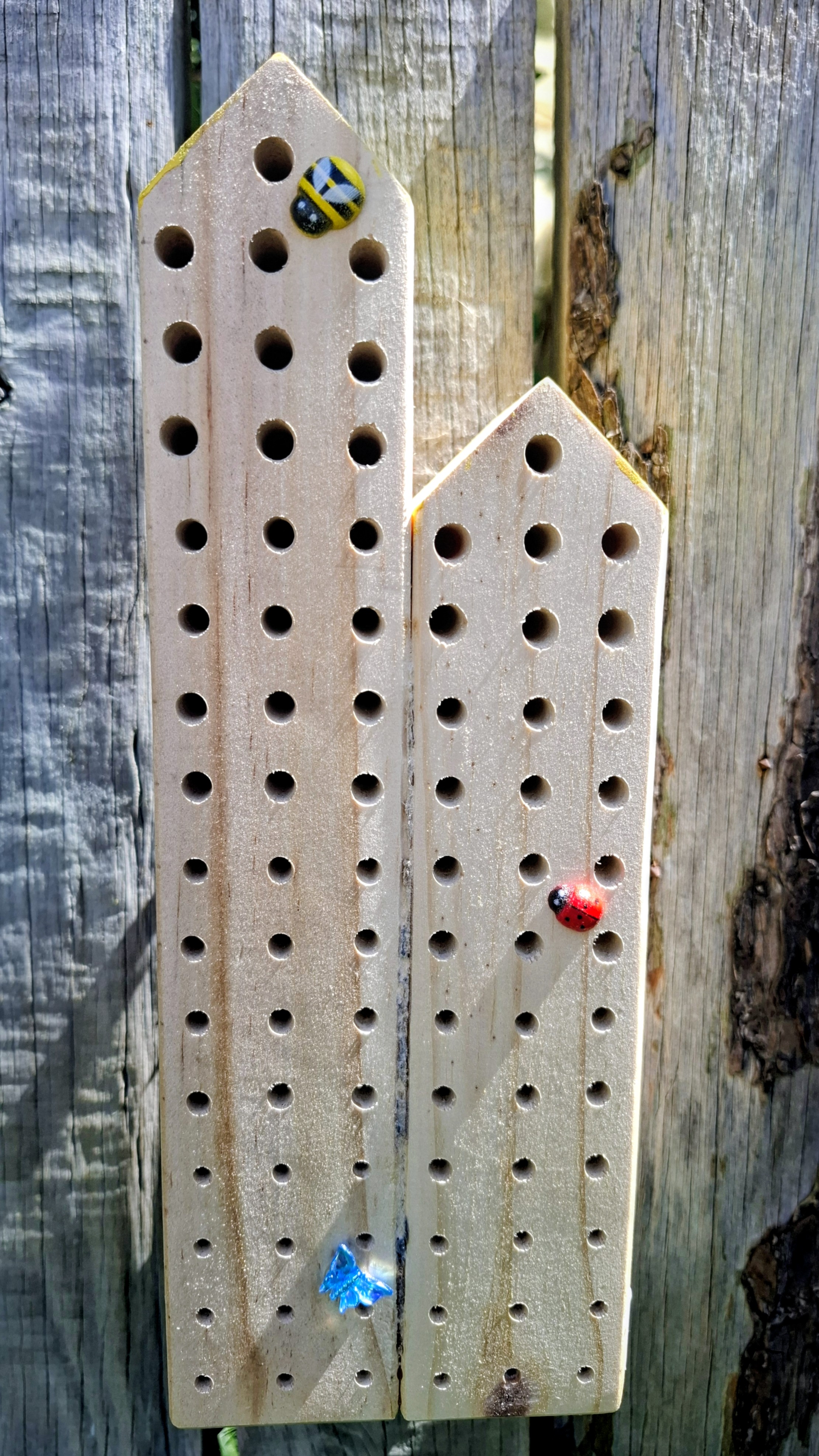 Wooden bee hotel with drilled holes